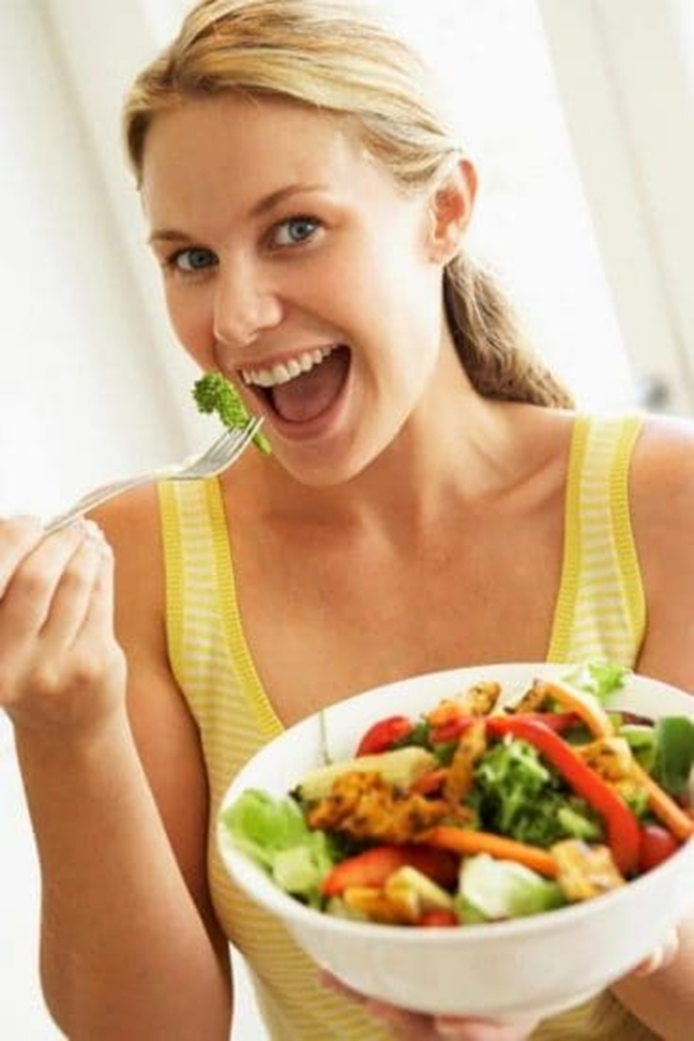 Woman-Laughing-Alone-with-Salad